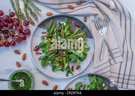 Spring salad with dandelion, asparagus, wild garlic, flowers Stock Photo