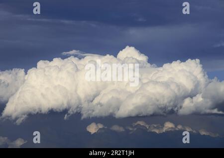 white cumulus clouds on dark blue sky of Sicily, Italy Stock Photo