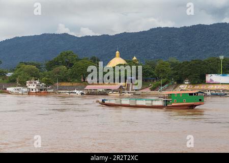 Sop Ruak, Thailand - September 7, 2018: Barge crossing the Golden Triangle on the Mekong River, Soap Ruak, Thailand. Stock Photo