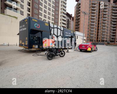 Elink station, Enoc Elink mobile fuel delivery service Dubai. Mobile petrol station in car park filling up vehicles Stock Photo