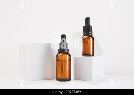 Two amber bottles with dropper pipettes for cosmetology. Stock Photo
