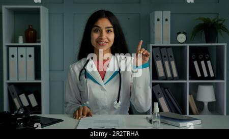 indian female doctor treating young patient Stock Photo - Alamy