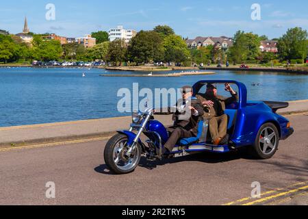 Poole, Dorset UK. 21st May 2023 Bournemouth and Poole Distinguished Gentlemen’s Ride is an annual event, one of many worldwide, to raise money and awareness for men’s health. As part of their ride, hundreds of motorbikes, many vintage,  ride through Poole Park on their way to Bournemouth with many of their riders dressed appropriately, in retro style cravats, moustaches and tweeds on a lovely sunny day. Credit: Carolyn Jenkins/Alamy Live News Stock Photo