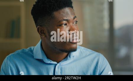 Thoughtful businessman adult ethnic African American man thinking indoors smart pondering executive worker manager specialist think planning dreaming Stock Photo