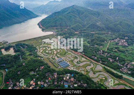 Guiping, China. 20th May, 2023. (230521) -- GUIPING, May 21, 2023 (Xinhua) -- This aerial photo shows the nature-imitated fishway of the auxiliary dam in Nanmu River, which is part of the Dateng Gorge water conservancy project in Guiping City, south China's Guangxi Zhuang Autonomous Region, May 20, 2023. Dateng Gorge water conservancy project is under construction on a section of Qianjiang River in Guiping, south China's Guangxi, where is an important spawning field for migration fishes in Zhujiang River basin. In order to protect fishes and the biodiversity of aquatic life in the Zhujiang Riv Stock Photo