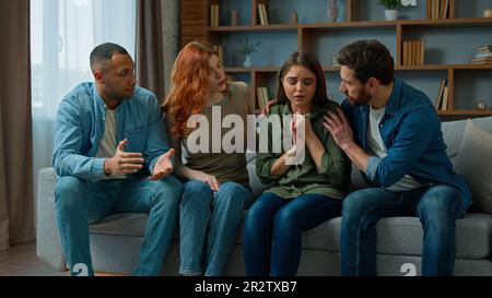Desperate sad woman cry complain life problem diverse women and men colleagues buddies support stressed girl multiracial team sit on psychological Stock Photo