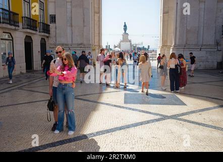 An influencer and companion who is holding her handbag pose for a selfie in Lisbon Stock Photo