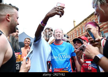 Sir Mo Farah poses with fans at the finish line of the 10k mens elite race during the AJ Bell Great Manchester Run 2023. Picture date: Sunday May 21, 2023. Stock Photo