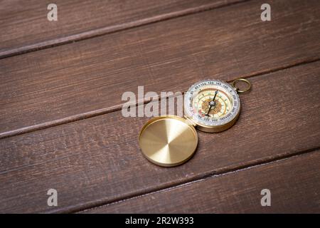 Scout and compass on wooden background Stock Photo