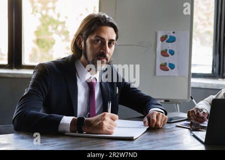 Handsome middle eastern man CEO manager singing papers Stock Photo