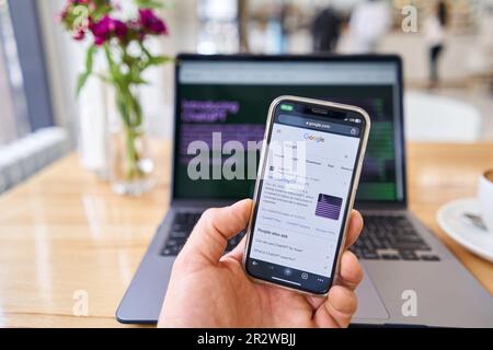 Spain, Barcelona - March 20 2023: Request to Google "chat GPT". ChatGPT chat bot screen seen on smartphone and laptop display with Chat GPT login Stock Photo