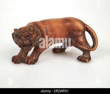 Antique Vintage Japanese hand carved wooden lion netsuke. Signed Stock Photo