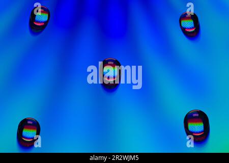 Waterdrops on a CD with blue light Stock Photo