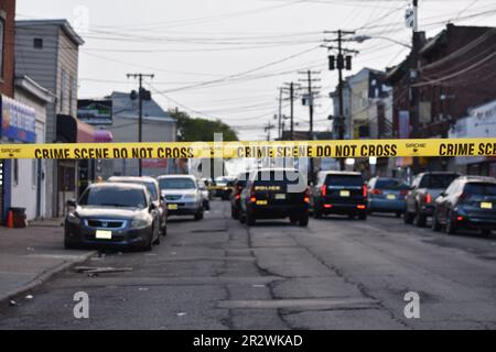 Crime scene tape blocks the area to pedestrians and vehicles where the shooting took place. Paterson police vehicles were staged at the crime scene securing the area. Multiple people were shot on River Street in Paterson, New Jersey Sunday morning around 2:30 AM Eastern Time. Crime Scene Investigation and Paterson police officers were on the scene gathering evidence from the area. Individuals who were shot were transported to the hospital by private cars. No official information was immediately available from the Paterson police. (Photo by Kyle Mazza/SOPA Images/Sipa USA) Stock Photo