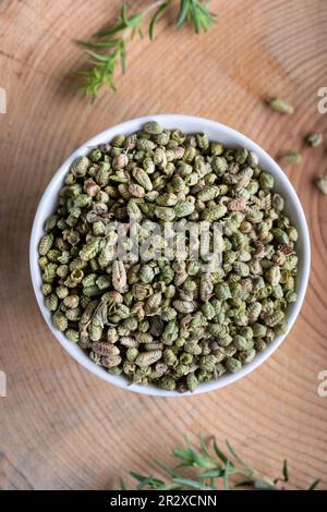 Fresh green aromatic thyme herbs with dried thyme seeds in a bowl. Stock Photo