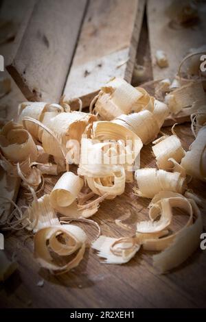 Boards and shavings after work on the carpenter's workbench. Stock Photo