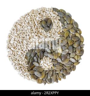 Yin and yang symbol made of hulled sunflower and pumpkin seeds isolated on white background. Stock Photo