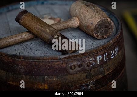 Hammer and chisel on whisky barrel Stock Photo