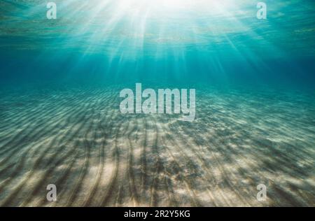 Sunlight under water surface with ripples of sand on the seabed in the Mediterranean sea, Spain Stock Photo