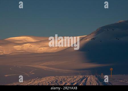 Kungsleden skiing and snowmobile trail between Viterskalet and Syter Mountain Huts in March, Lapland, Sweden Stock Photo