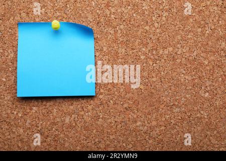 Blank paper note pinned to cork background. Space for text Stock Photo