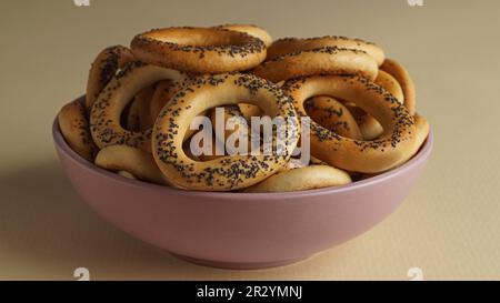 Bowl with delicious ring shaped Sushki (dry bagels) on beige background, closeup Stock Photo