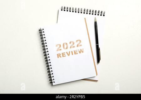 Text 2022 Review written in notebook and pen on white background, top view Stock Photo