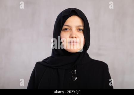 Portrait of young serious woman in hijab posing in studio Stock Photo