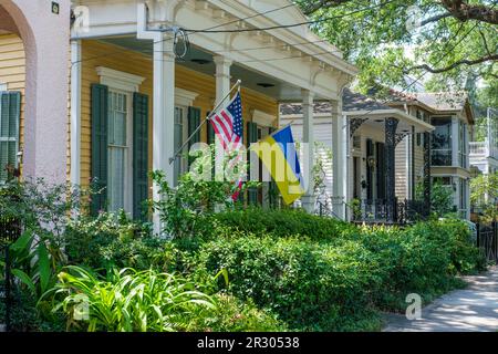 NEW ORLEANS, LA, USA - MAY 14, 2023: Cityscape of Uptown homes and displayed American and Ukrainian flags Stock Photo