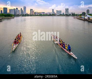 Dragon Boats practicing in Kallang Basin, near Singapore Sports Hub. It is a sports and recreation district in Kallang, Singapore. Stock Photo