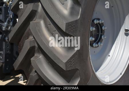 Tractor tire close up.  Tractor tire mounted on white wheel Stock Photo