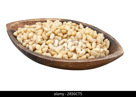 Pine nuts in a wooden bowl isolated on a white background Stock Photo