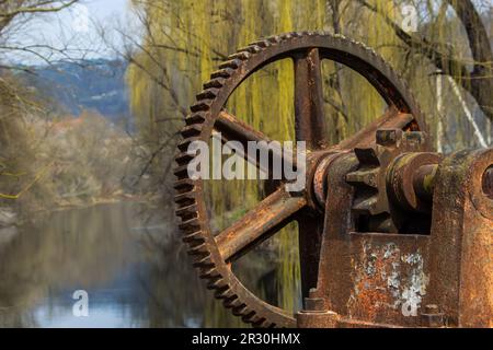 old mechanical metal gears mechanism on the abandoned dam. Stock Photo