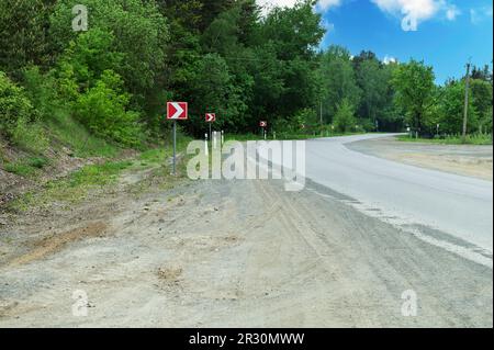 Turn signals on a country road. Signal turn right. Road signs. Stock Photo