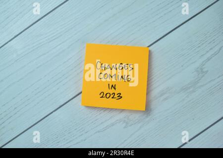 Concept of Changes Coming in 2023 write on sticky notes isolated on Wooden Table. Stock Photo