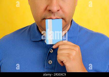 Forty-year-old dark-skinned Latino adult man shows his credit card to make payments, online purchases for months without interest Stock Photo