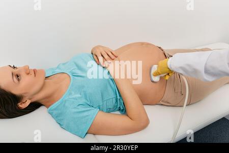 Prenatal screening and testing. Sonographer doing ultrasound examination of pregnant woman in hospital Stock Photo