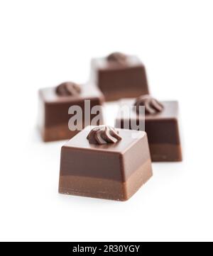 Sweet chocolate pralines.  Tasty chocolate truffles isolated on the white background. Stock Photo