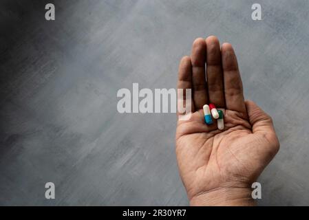Colorful medicine pills in hand with copy space for text. Medical and healthcare concept Stock Photo