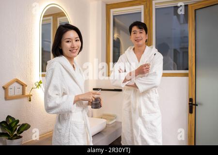 Happy young Chinese couple brushing teeth Stock Photo