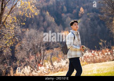 Young man taking photos outdoors Stock Photo