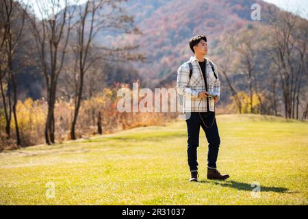 Young man taking photos outdoors Stock Photo