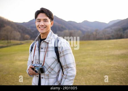 Portrait of happy photographer Stock Photo