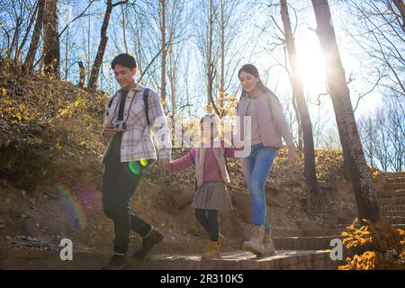 Happy young family hiking outdoors Stock Photo