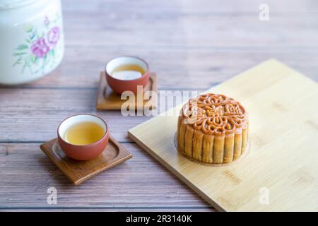 Moon cake served with chinese tea. Mid-autumn festival concept. Copy space. Stock Photo