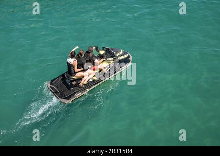 A family of holidaymakers sitting on a Yamaha Jet Ski in Newquay Harbour Harbor in Cornwall in England in the UK. Stock Photo