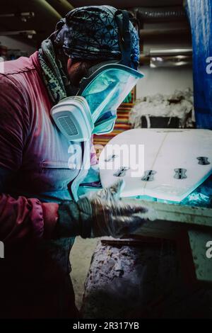 Portrait of a shaper from Tenerife working on a new surfboard Stock Photo