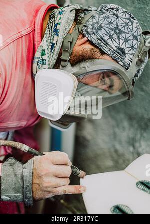 A local surf shaper from Tenerife working on a new surfboard Stock Photo