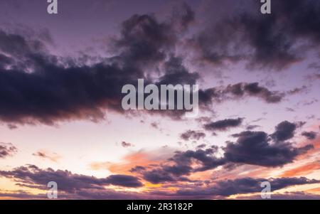 dramatic cloudscape at dusk. sky in colorful evening light. changing weather forecast Stock Photo