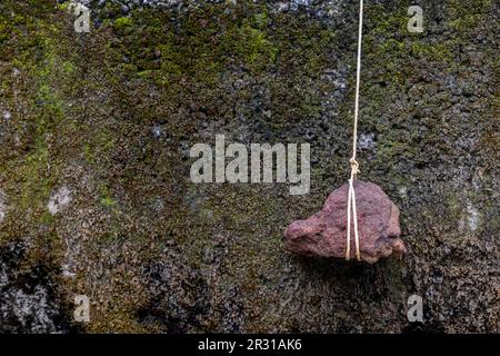 Stone Hanging By A String On White Stock Photo, Picture and